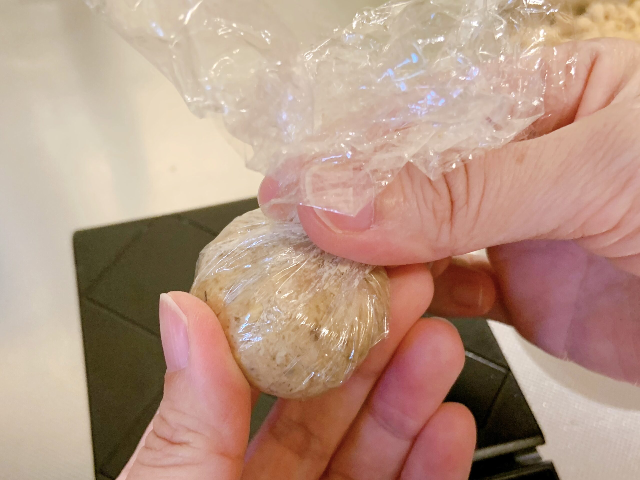 栗きんとんを作るために蒸した栗を茶巾絞りしているところ