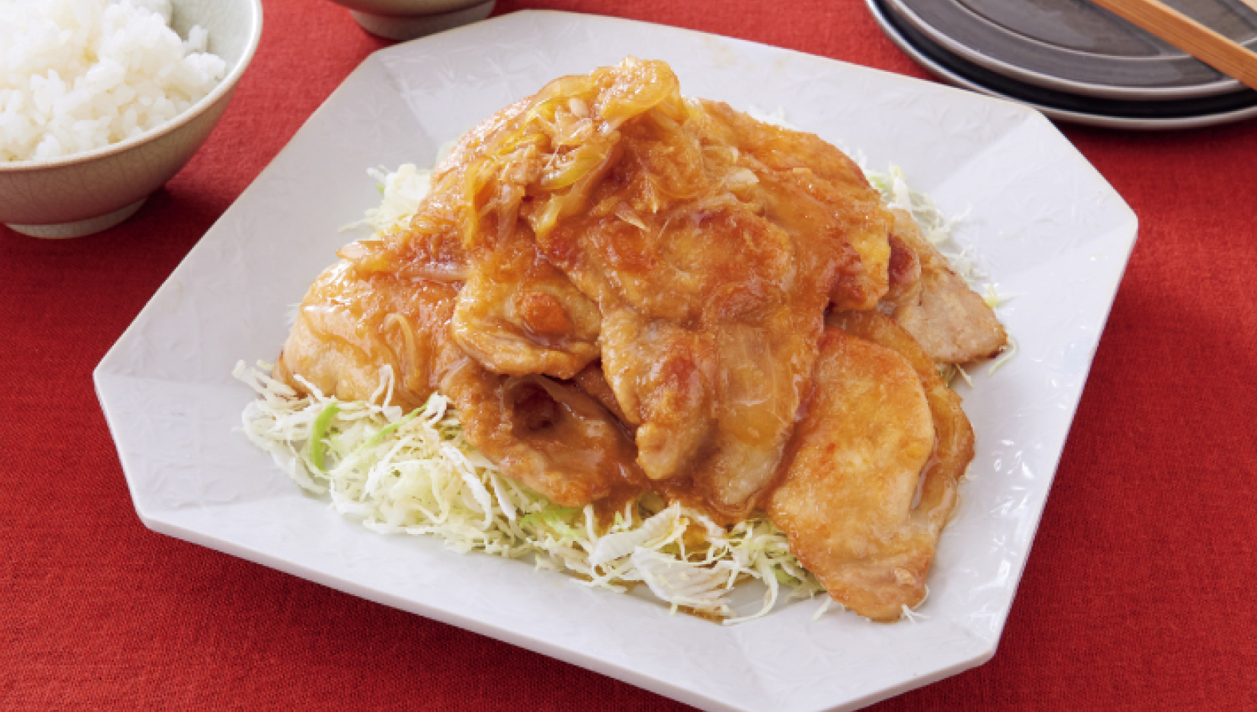 豚肉の生姜焼きとキャベツの千切り。その横に茶碗に盛られた白米。