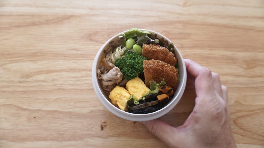 ダイソーのスープジャーに炊き立てご飯を入れたお弁当。おかずはコロッケ、卵焼き、レンコンのひじき煮、マカロニ、豚生姜焼きです。