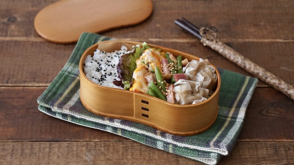 曲げわっぱでタイパ弁当。平たく焼いた卵と冷凍しゅうまい、インゲンのベーコン炒めを詰めて大満足なお弁当。